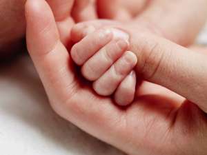 Baby's hands in nurse's hands